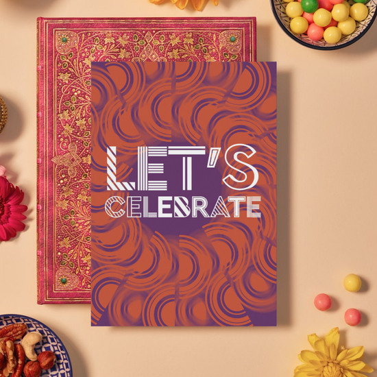 Vibrant celebration card with bold white text that reads ‘LET’S CELEBRATE’ in a mix of striped and outlined fonts. The background features an intricate orange mandala pattern layered over a deep purple backdrop, creating a dynamic and festive design full of energy and movement.