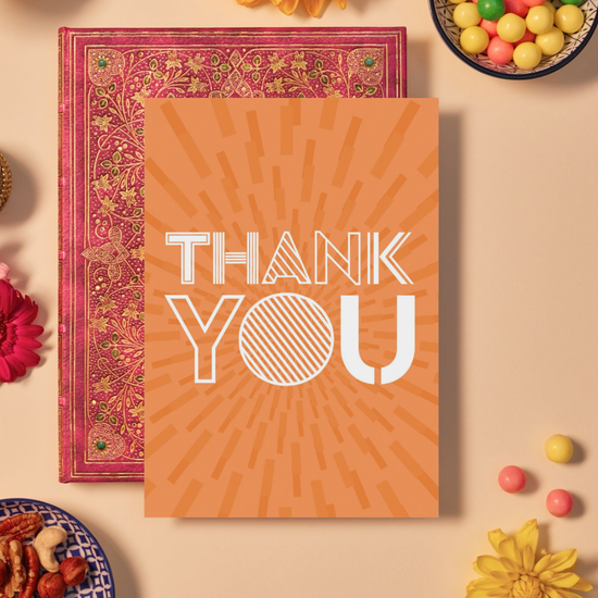 Card with bold white text reading ‘THANK YOU’ in a mix of outlined and striped geometric fonts. The background is a bright orange featuring a mandala-like burst pattern made of radiating rectangular shapes, creating a dynamic and energetic sense of gratitude and appreciation.