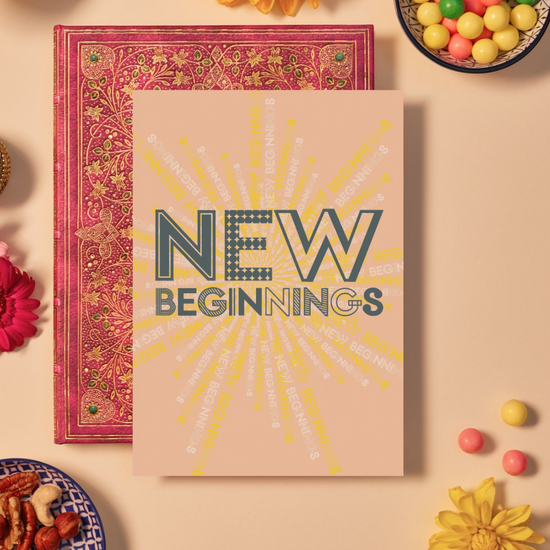 Card with bold dark grey text reading ‘NEW BEGINNINGS’ in a mix of dotted, striped, and outlined geometric fonts. The background is a soft peach color featuring a radiant mandala pattern made from repeating the phrase ‘NEW BEGINNINGS’ in shades of yellow, white, and grey, spiraling outward to symbolize growth, change, and optimism. 